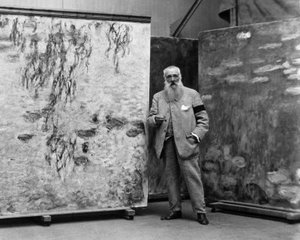 Monet with paintings.jpg